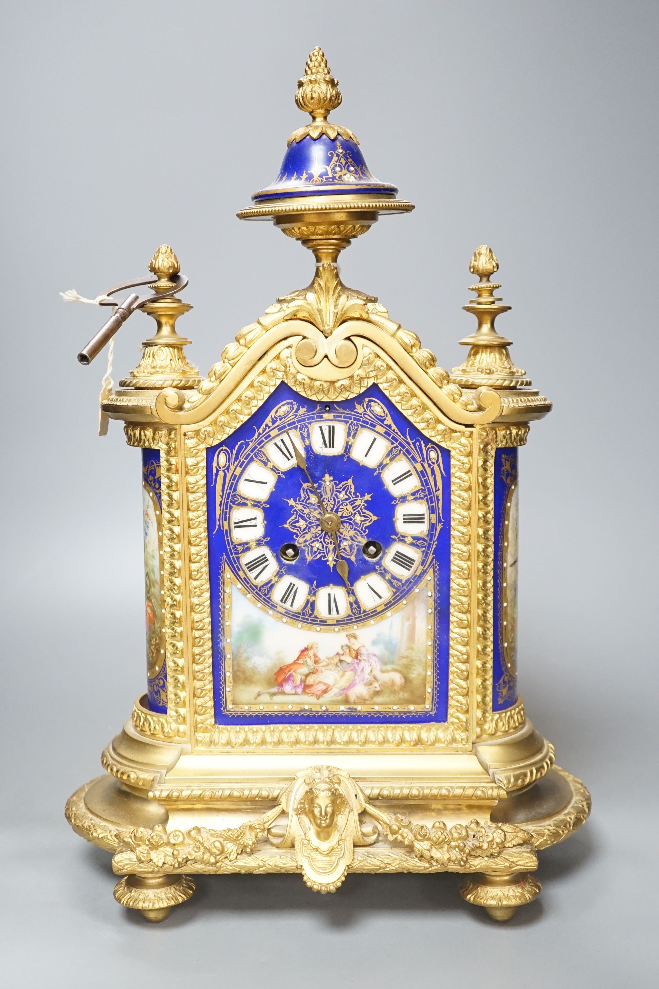 A 19th century French ormolu cased mantel clock, with decorated porcelain panels and face, eight day movement with strike, 40cm high